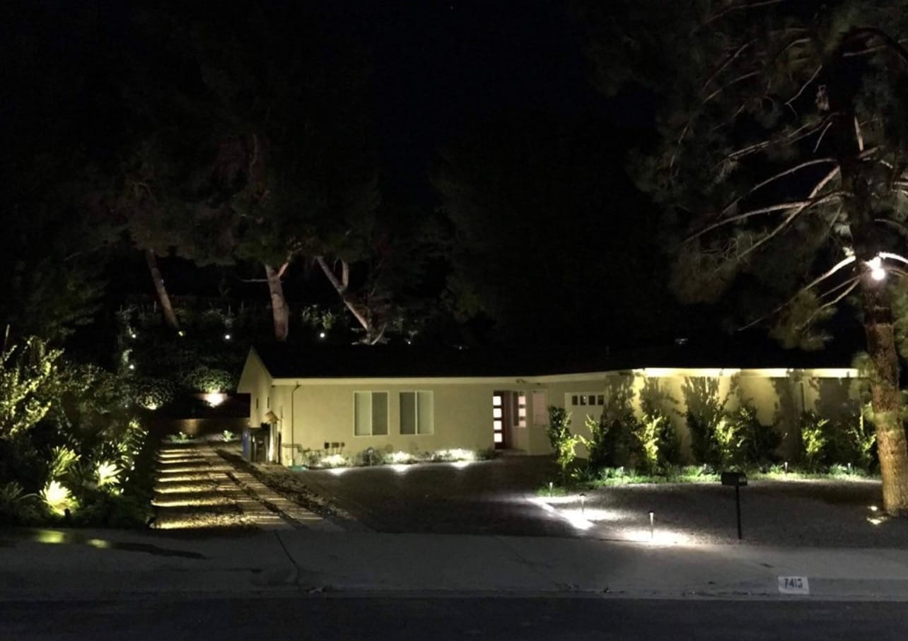 Full front-yard landscape lighting at dusk