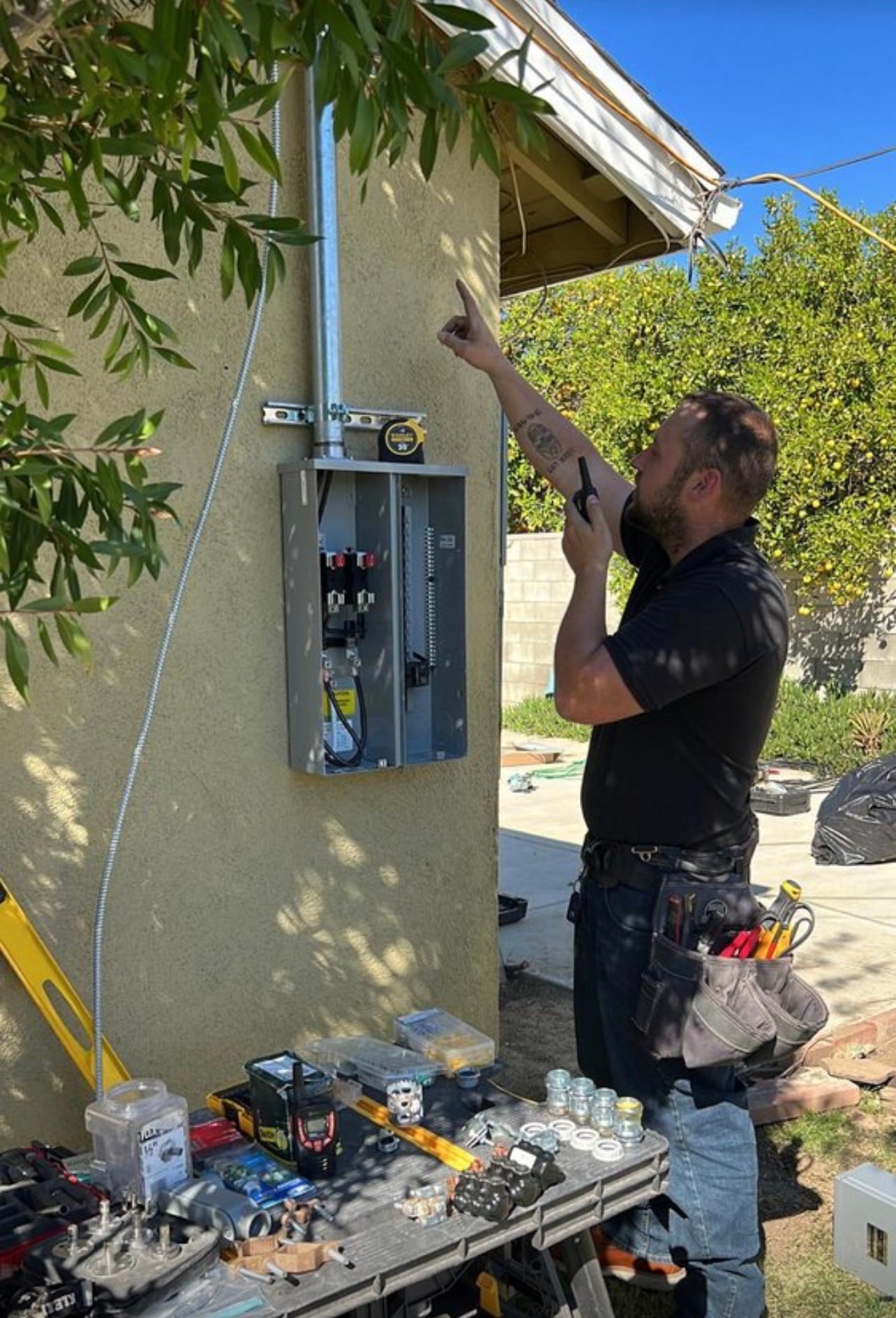 Technician installing a new meter panel outdoors