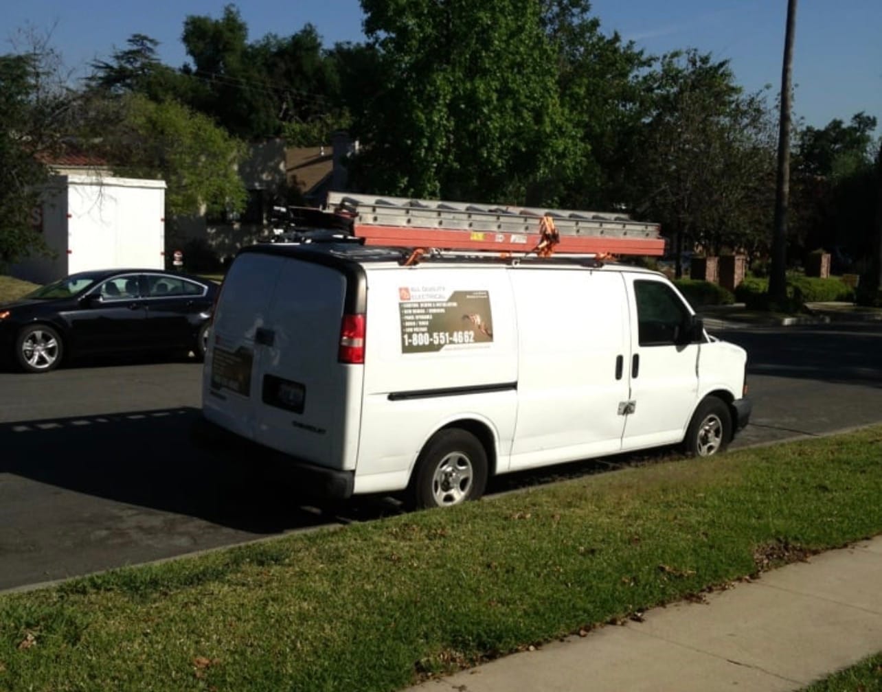 AQE service van parked on a residential street